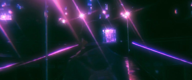 Photo of the back of a person wearing a backpack, city lights reflective and shining in pinks and blues