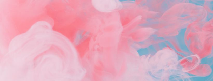 Abstract photo of pink coloured smoke on a blue background.